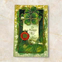 Antique 1913 New Year postcard featuring embossed four-leaf clovers, gilded scroll with greeting, and red seal motif; preserved message on reverse, marked Made in Saxony.