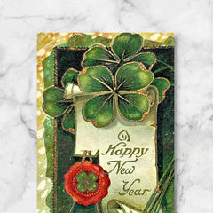 Antique 1913 New Year postcard featuring embossed four-leaf clovers, gilded scroll with greeting, and red seal motif; preserved message on reverse, marked Made in Saxony.