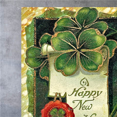 Antique 1913 New Year postcard featuring embossed four-leaf clovers, gilded scroll with greeting, and red seal motif; preserved message on reverse, marked Made in Saxony.