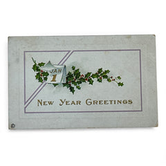 Embossed vintage New Year postcard with holly leaves and berries framing a gold “JAN 1” calendar; “New Year Greetings” printed in gold below. Made by Stechler Litho Co., postmarked December 1920.