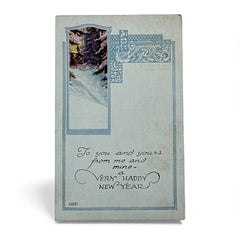 Printed vintage New Year postcard with a snowy forest illustration and ornate blue scrollwork; greeting reads “To you and yours from me and mine — a VERY HAPPY NEW YEAR.” Postmarked December 1923.