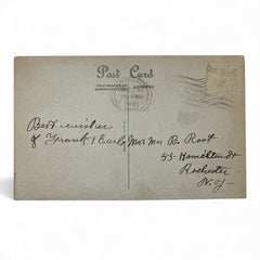 Printed vintage New Year postcard with a snowy forest illustration and ornate blue scrollwork; greeting reads “To you and yours from me and mine — a VERY HAPPY NEW YEAR.” Postmarked December 1923.