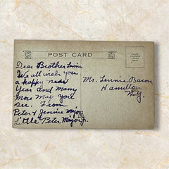 Antique 1910s New Year postcard showing a silver moonlit church and town skyline reflected on a river, with ornate red lettering “To Wish You A Happy New Year” and handwritten family message on reverse, very good condition with light corner wear.