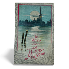Antique 1910s New Year postcard showing a silver moonlit church and town skyline reflected on a river, with ornate red lettering “To Wish You A Happy New Year” and handwritten family message on reverse, very good condition with light corner wear.