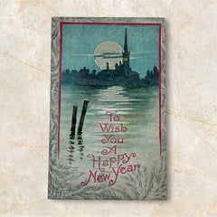 Antique 1910s New Year postcard showing a silver moonlit church and town skyline reflected on a river, with ornate red lettering “To Wish You A Happy New Year” and handwritten family message on reverse, very good condition with light corner wear.