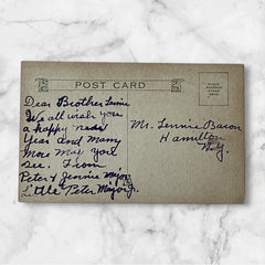 Antique 1910s New Year postcard showing a silver moonlit church and town skyline reflected on a river, with ornate red lettering “To Wish You A Happy New Year” and handwritten family message on reverse, very good condition with light corner wear.