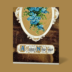 Antique 1910s New Year postcard featuring embossed blue forget-me-not flowers in a gold-gilded oval frame, set against a textured brown background resembling crocodile skin; elegant and well-preserved with handwritten 1913 message on reverse.