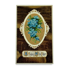 Antique 1910s New Year postcard featuring embossed blue forget-me-not flowers in a gold-gilded oval frame, set against a textured brown background resembling crocodile skin; elegant and well-preserved with handwritten 1913 message on reverse.