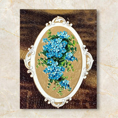 Antique 1910s New Year postcard featuring embossed blue forget-me-not flowers in a gold-gilded oval frame, set against a textured brown background resembling crocodile skin; elegant and well-preserved with handwritten 1913 message on reverse.