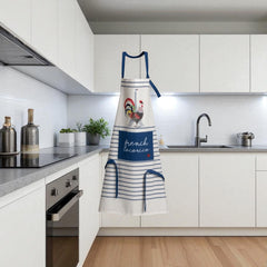 Eco-friendly French kitchen apron featuring a stylized rooster and Eiffel Tower illustration with the phrase 'French Cocorico' on a white background with blue stripes and matching blue ties.