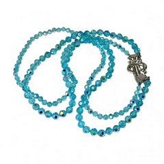 Vintage double‑strand aqua blue AB crystal necklace with faceted beads and a silver‑tone pavé rhinestone brooch clasp, shown from multiple angles to highlight bead size, sparkle, and clasp detailing.