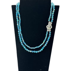 Vintage double‑strand aqua blue AB crystal necklace with faceted beads and a silver‑tone pavé rhinestone brooch clasp, shown from multiple angles to highlight bead size, sparkle, and clasp detailing.