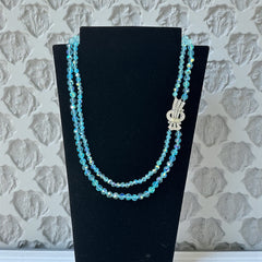 Vintage double‑strand aqua blue AB crystal necklace with faceted beads and a silver‑tone pavé rhinestone brooch clasp, shown from multiple angles to highlight bead size, sparkle, and clasp detailing.