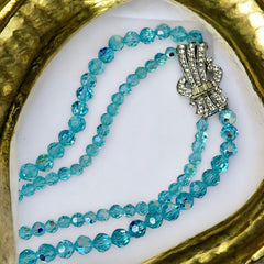 Vintage double‑strand aqua blue AB crystal necklace with faceted beads and a silver‑tone pavé rhinestone brooch clasp, shown from multiple angles to highlight bead size, sparkle, and clasp detailing.
