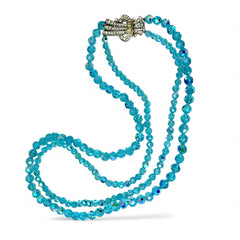 Vintage double‑strand aqua blue AB crystal necklace with faceted beads and a silver‑tone pavé rhinestone brooch clasp, shown from multiple angles to highlight bead size, sparkle, and clasp detailing.