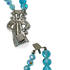 Vintage double‑strand aqua blue AB crystal necklace with faceted beads and a silver‑tone pavé rhinestone brooch clasp, shown from multiple angles to highlight bead size, sparkle, and clasp detailing.