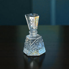 Vintage Czech hand-cut glass perfume bottle with faceted hexagon base and original stopper, shown in varied lighting to highlight its Art Deco silhouette and reflective clarity.