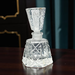Vintage Czech hand-cut glass perfume bottle with faceted hexagon base and original stopper, shown in varied lighting to highlight its Art Deco silhouette and reflective clarity.