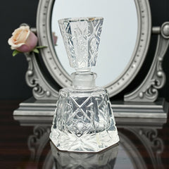 Vintage Czech hand-cut glass perfume bottle with faceted hexagon base and original stopper, shown in varied lighting to highlight its Art Deco silhouette and reflective clarity.