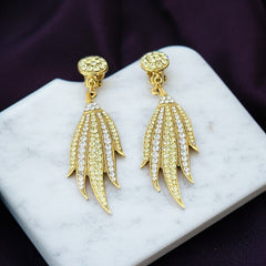 Vintage gold-tone clip-on earrings with jonquil and clear rhinestones in a feather-like Art Deco revival design; long dangle silhouette, 1970s style.