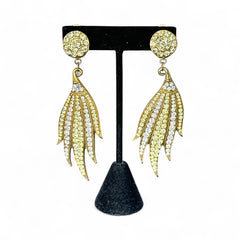 Vintage gold-tone clip-on earrings with jonquil and clear rhinestones in a feather-like Art Deco revival design; long dangle silhouette, 1970s style.