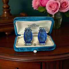 Vintage clip-on earrings featuring large cobalt blue oval rhinestones with light blue chaton accents in silver-tone Art Deco-style settings, mid-century design.