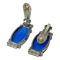 Vintage clip-on earrings featuring large cobalt blue oval rhinestones with light blue chaton accents in silver-tone Art Deco-style settings, mid-century design.