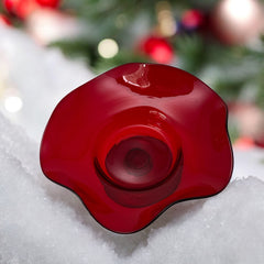 Vintage ruby red hand-blown glass bowl with a freeform wavy rim and clear pedestal base, photographed from above to highlight its organic curves and glossy surface. Midcentury compote style, ideal for decorative or serving use.