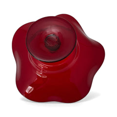 Vintage ruby red hand-blown glass bowl with a freeform wavy rim and clear pedestal base, photographed from above to highlight its organic curves and glossy surface. Midcentury compote style, ideal for decorative or serving use.