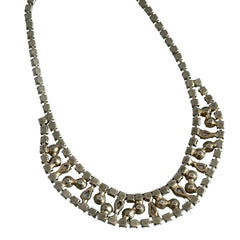 A vintage Astra necklace featuring glowing faux opal cabochons and deep amethyst stones in a double‑row midcentury design, shown on a neutral background to highlight its color and detail.