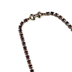 A vintage Astra necklace featuring glowing faux opal cabochons and deep amethyst stones in a double‑row midcentury design, shown on a neutral background to highlight its color and detail.