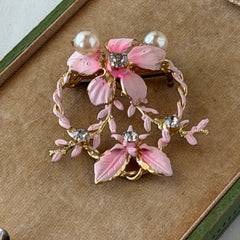 Vintage Austrian pink enamel floral heart brooch with faux pearls and rhinestones on gold‑plated heart frame.