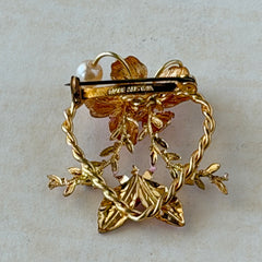 Vintage Austrian pink enamel floral heart brooch with faux pearls and rhinestones on gold‑plated heart frame.