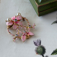 Vintage Austrian pink enamel floral heart brooch with faux pearls and rhinestones on gold‑plated heart frame.