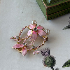 Vintage Austrian pink enamel floral heart brooch with faux pearls and rhinestones on gold‑plated heart frame.
