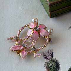 Vintage Austrian pink enamel floral heart brooch with faux pearls and rhinestones on gold‑plated heart frame.