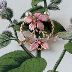 Vintage Austrian pink enamel floral heart brooch with faux pearls and rhinestones on gold‑plated heart frame.