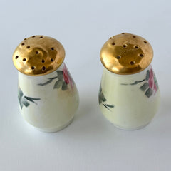 Vintage Austrian porcelain salt and pepper shakers hand‑painted with pink roses and gold tops, shown from multiple angles on a white background.
