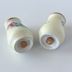 Vintage Austrian porcelain salt and pepper shakers hand‑painted with pink roses and gold tops, shown from multiple angles on a white background.