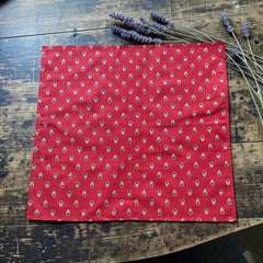 Provence cotton napkins in red and yellow floral Avignon pattern by Marat d’Avignon, displayed in soft natural light.