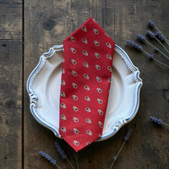 Provence cotton napkins in red and yellow floral Avignon pattern by Marat d’Avignon, displayed in soft natural light.
