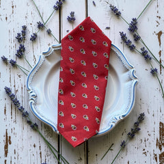 Provence cotton napkins in red and yellow floral Avignon pattern by Marat d’Avignon, displayed in soft natural light.