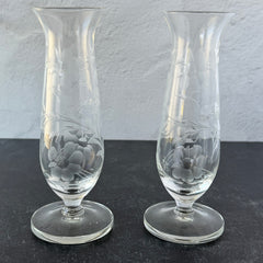 Pair of vintage Avon etched glass pedestal vases with frosted floral design and flared rim.