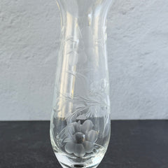 Pair of vintage Avon etched glass pedestal vases with frosted floral design and flared rim.