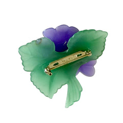 Vintage 1983 Avon brooch with frosted purple resin violets, green leaves, and faux‑pearl centers.