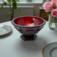 Vintage Avon ruby red glass compote with scalloped rim and pedestal base, featuring embossed Cape Cod pattern and rich crimson hue; a collectible 1970s–1990s candy dish styled for festive tables or vintage decor.