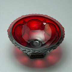 Vintage Avon ruby red glass compote with scalloped rim and pedestal base, featuring embossed Cape Cod pattern and rich crimson hue; a collectible 1970s–1990s candy dish styled for festive tables or vintage decor.