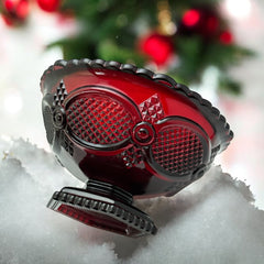 Vintage Avon ruby red glass compote with scalloped rim and pedestal base, featuring embossed Cape Cod pattern and rich crimson hue; a collectible 1970s–1990s candy dish styled for festive tables or vintage decor.