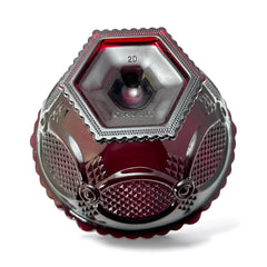 Vintage Avon ruby red glass compote with scalloped rim and pedestal base, featuring embossed Cape Cod pattern and rich crimson hue; a collectible 1970s–1990s candy dish styled for festive tables or vintage decor.