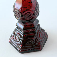 Vintage Avon 1876 Cape Cod Collection ruby red glass perfume bottle and candlestick holder with hexagonal base and ornate embossed pattern,.